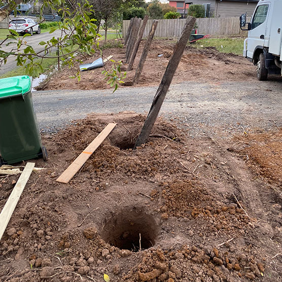putting a fence posts with mini excavator